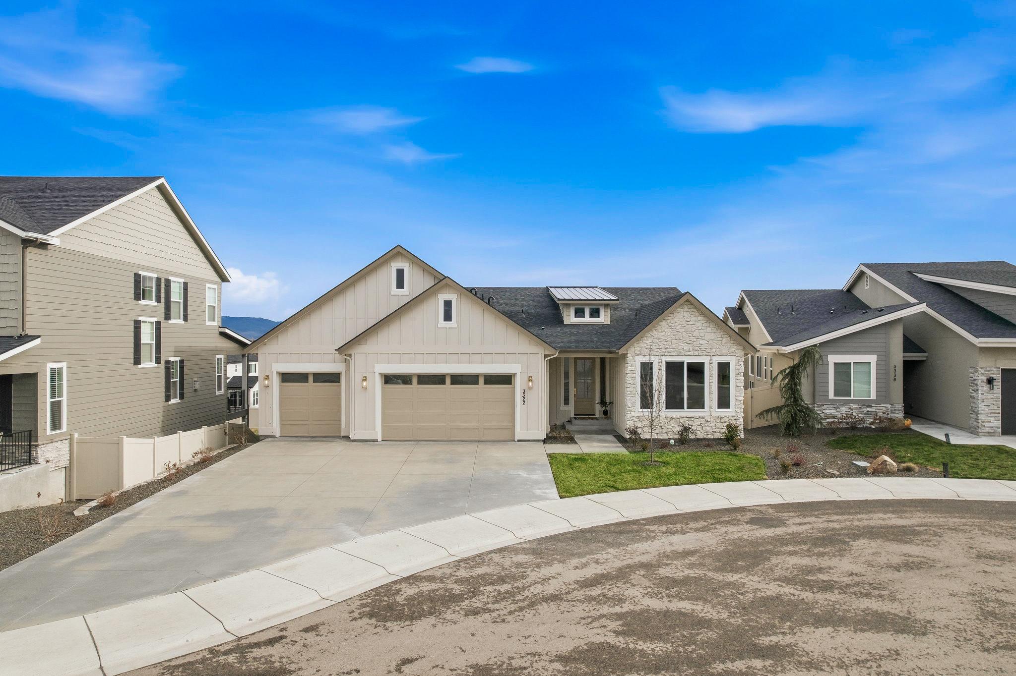 The front of 3322 S Volunteer Place in Meridian: board and batten siding, stone accents, and a three car garage